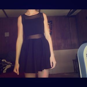 Black cocktail dress with mesh straps and stomach